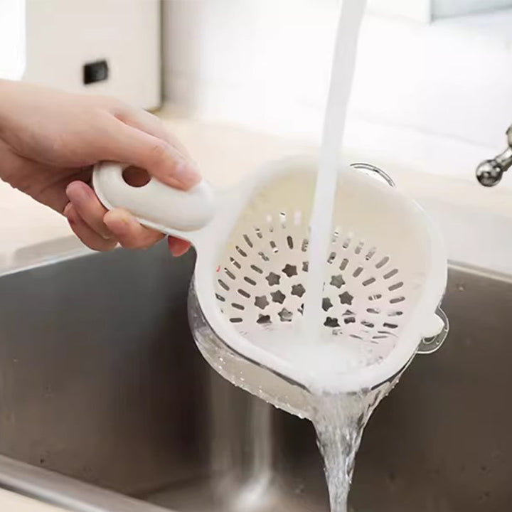 Plastic drainer basket filled with fresh berries during fruit washing