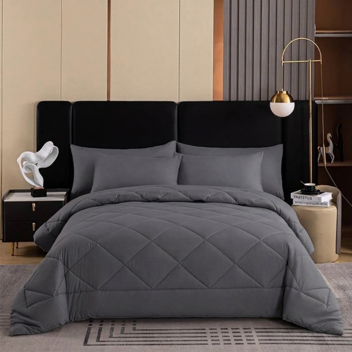 Dark grey quilted bedspread and pillow sham set showcasing diamond stitching texture