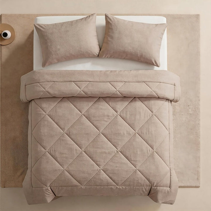 Elegant bedroom decor featuring a patterned quilted comforter and pillows