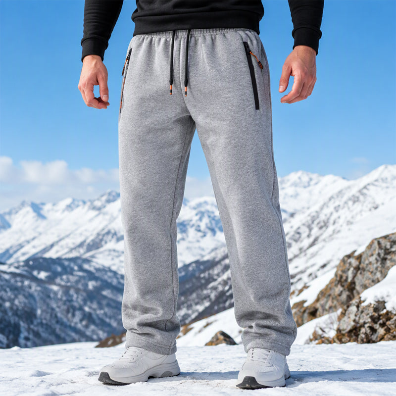 Men's winter comfortable thermal sweatpants in light gray worn outdoors in snowy mountains