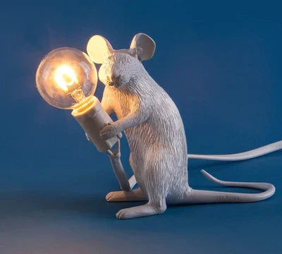 Unique mouse lamp casting warm ambient glow in bedroom decor