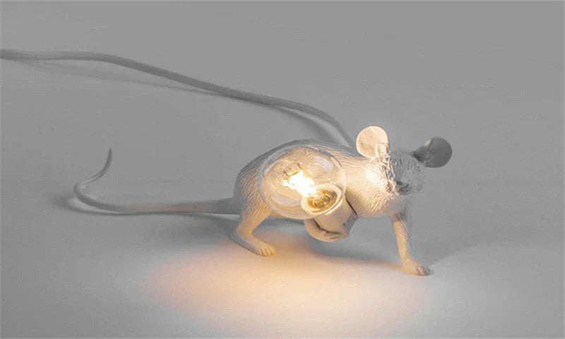Close-up of decorative mouse novelty desk lamp holding light bulb