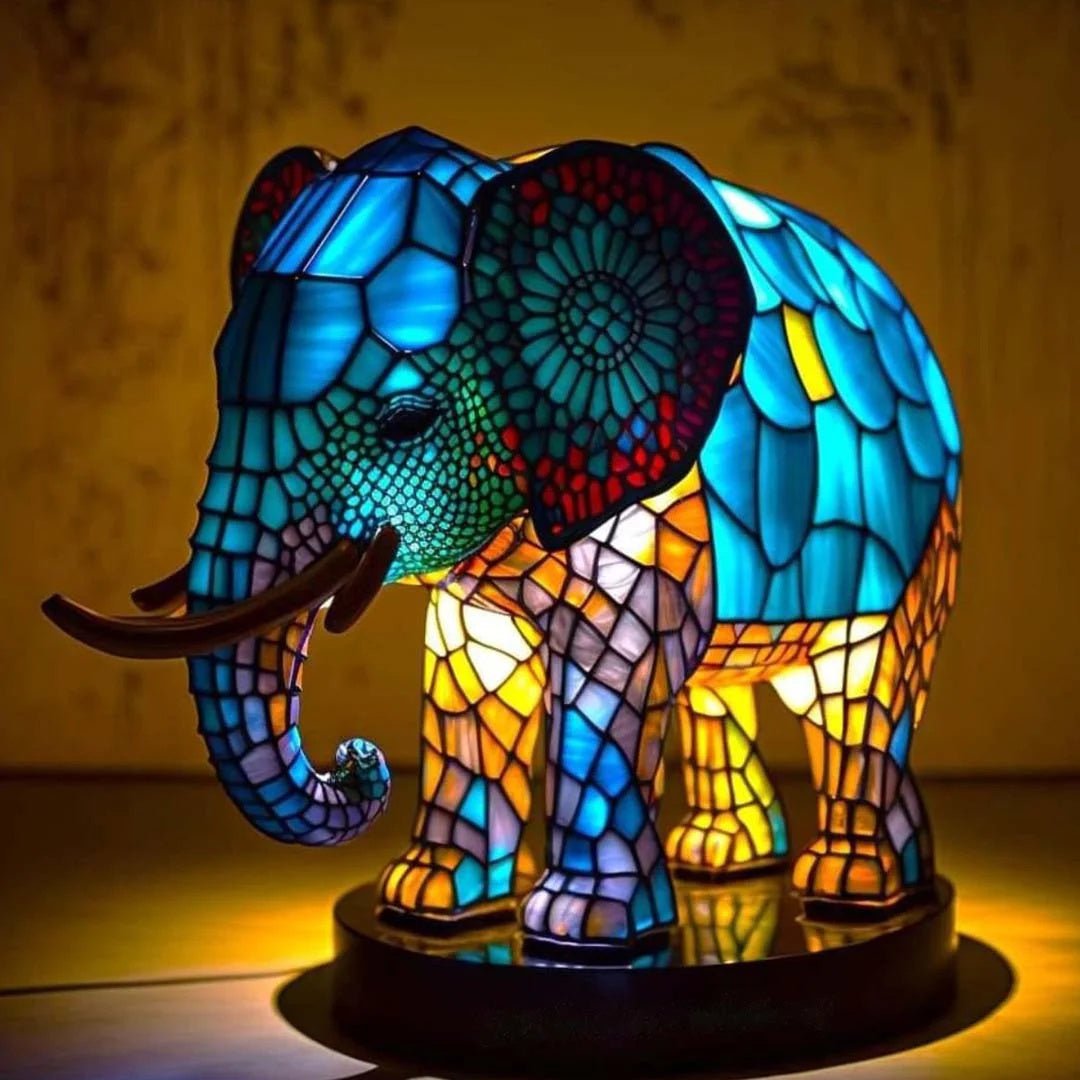 Stained glass elephant table lamp glowing with warm blue and yellow LED lights