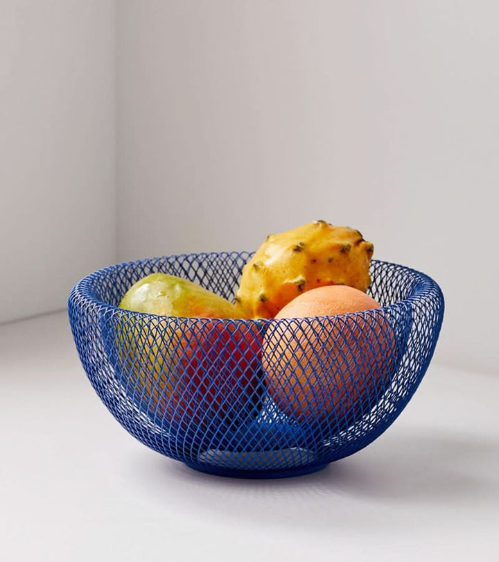 Blue steel mesh fruit basket filled with fresh tropical fruit
