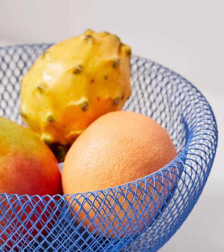 Close up of black steel mesh bowl for kitchen produce organization