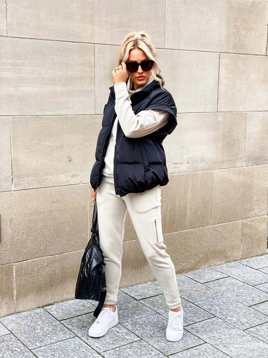 Woman wearing a black sleeveless puffer vest outdoors