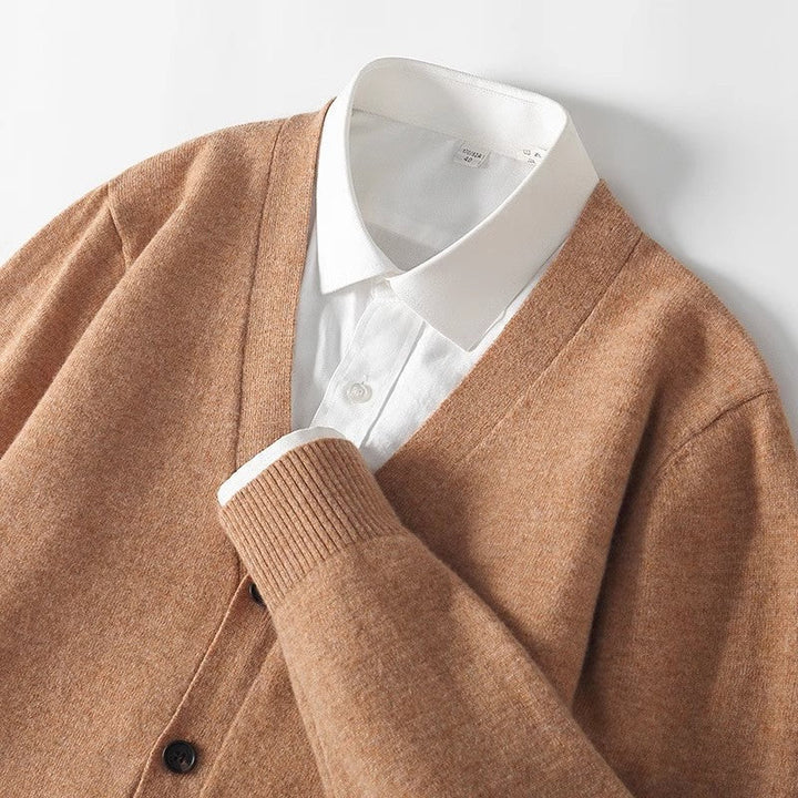 Detailed shot of textured knit fabric and button closure on men's cardigan