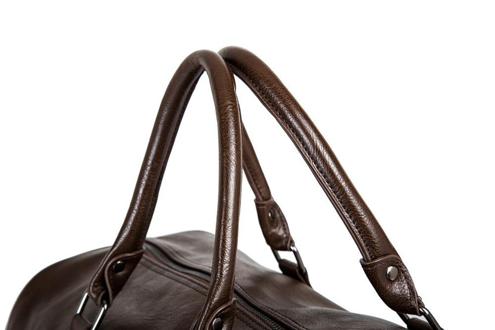 Top-down view of open weekender carry-on bag packed for a trip