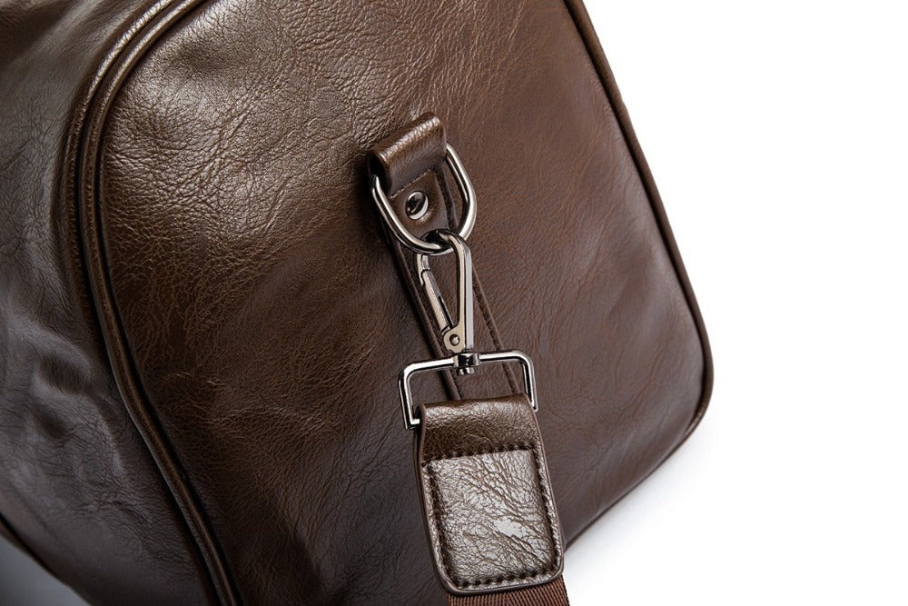 Model carrying brown leather weekender bag in an airport setting