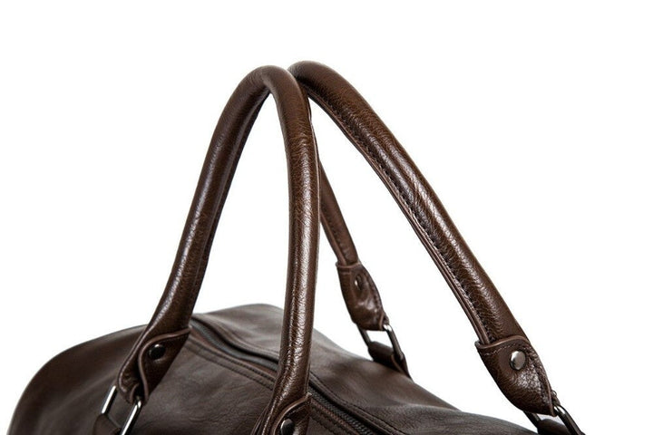 Durable metal bottom studs on base of travel duffel bag