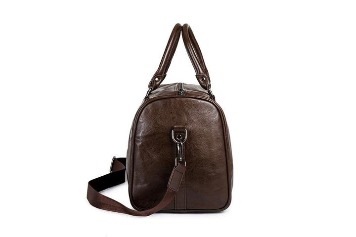 Close-up of premium metal zipper closure on brown travel duffel