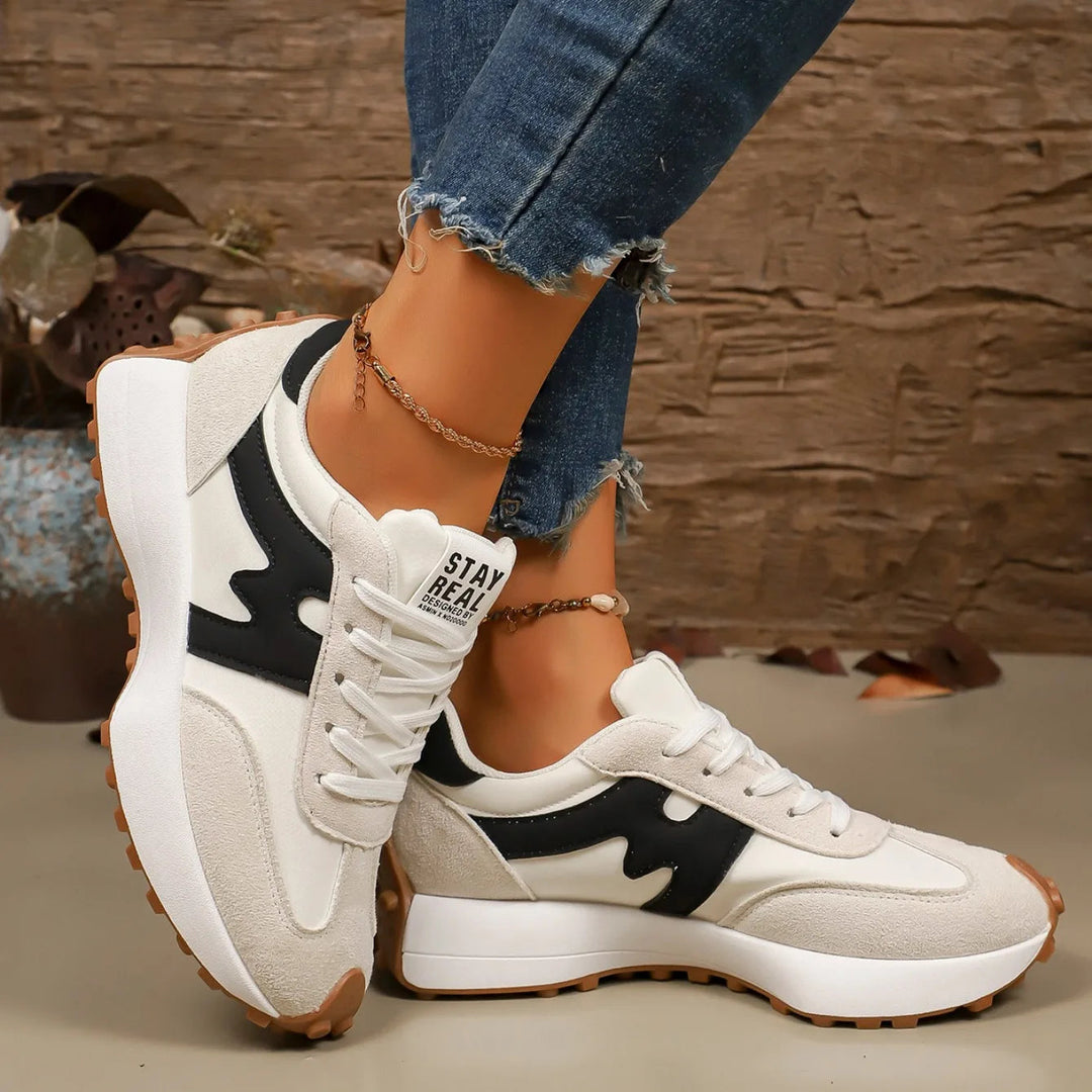 Side profile of women's striped platform sneakers showing chunky sole and casual design