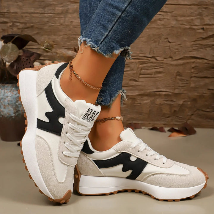 Side profile of women's striped platform sneakers showing chunky sole and casual design