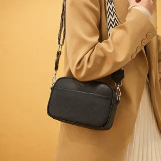Everyday crossbody bag flat lay showing front pocket and hardware