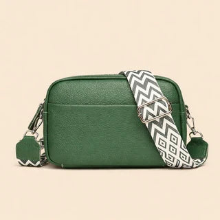 Minimalist crossbody bag angled view showing zipper and strap
