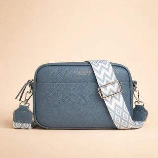 Blue minimalist crossbody bag with patterned strap