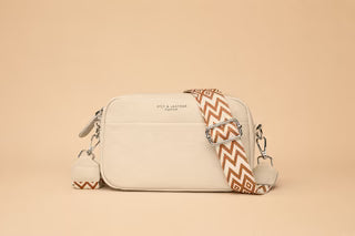 Beige minimalist crossbody bag with patterned strap