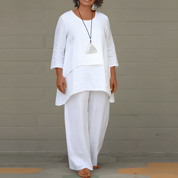 A woman modeling the clean white two-piece matching outfit with a relaxed silhouette.
