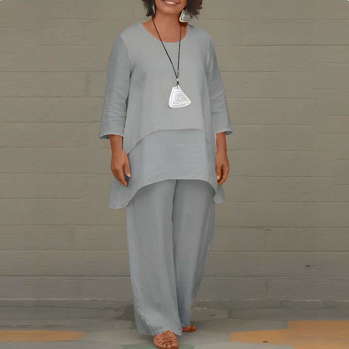 A woman showcasing the elegant gray two-piece set with long sleeves and comfortable pants.