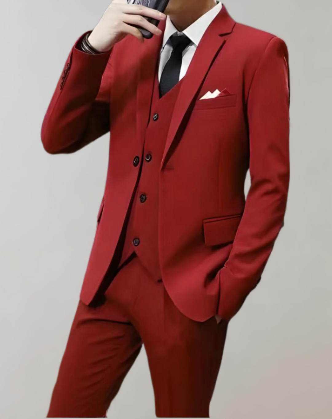 Man wearing a bold red 3-piece suit standing confidently
