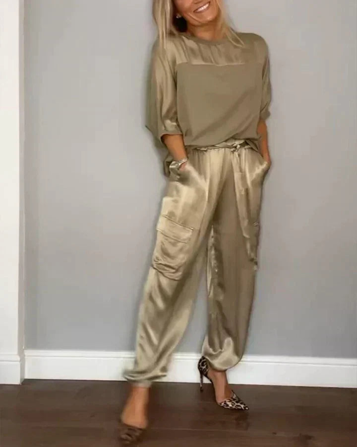 Woman wearing a gold satin jumpsuit with heels
