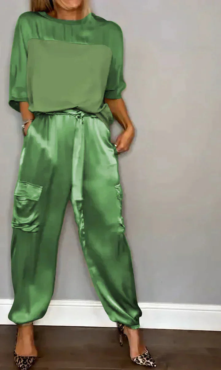 Chic women's party outfit featuring a smooth satin fabric one-piece
