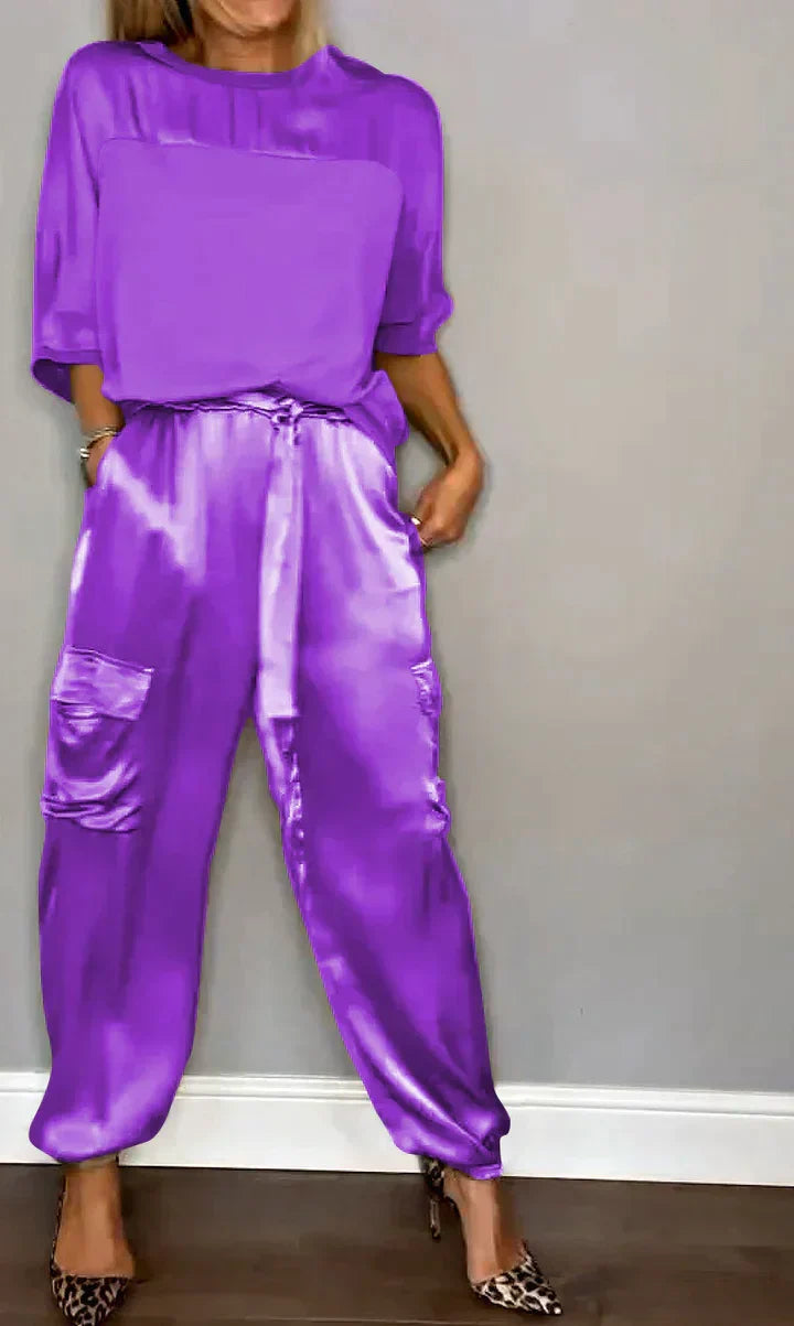 Woman wearing a purple satin jumpsuit