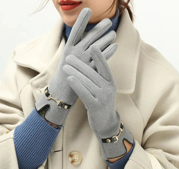 Woman wearing sophisticated grey winter gloves with decorative strap