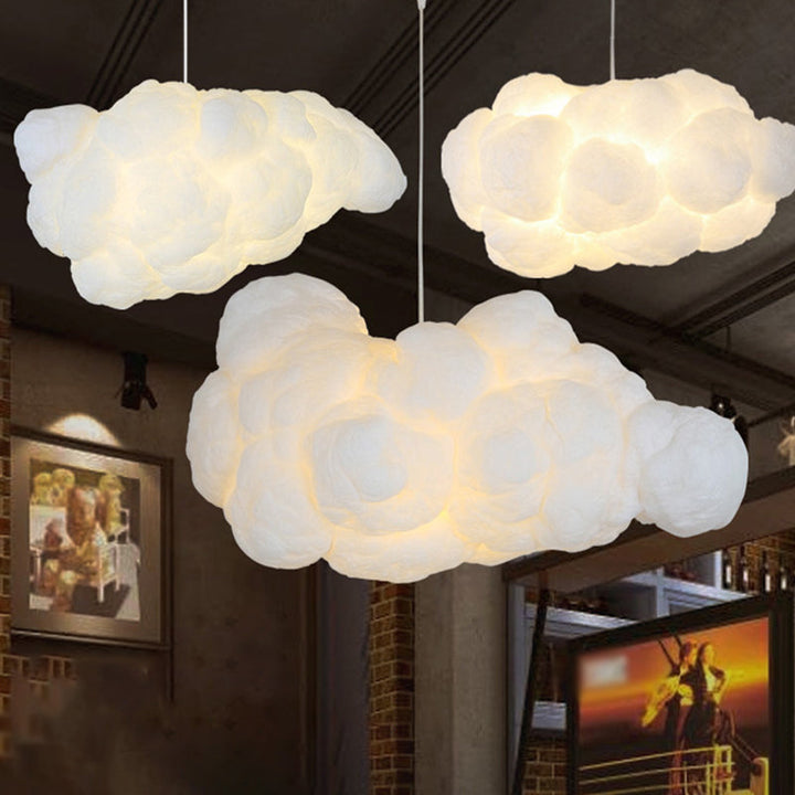 Multiple white cloud ceiling lamps hanging in a stylish interior setting