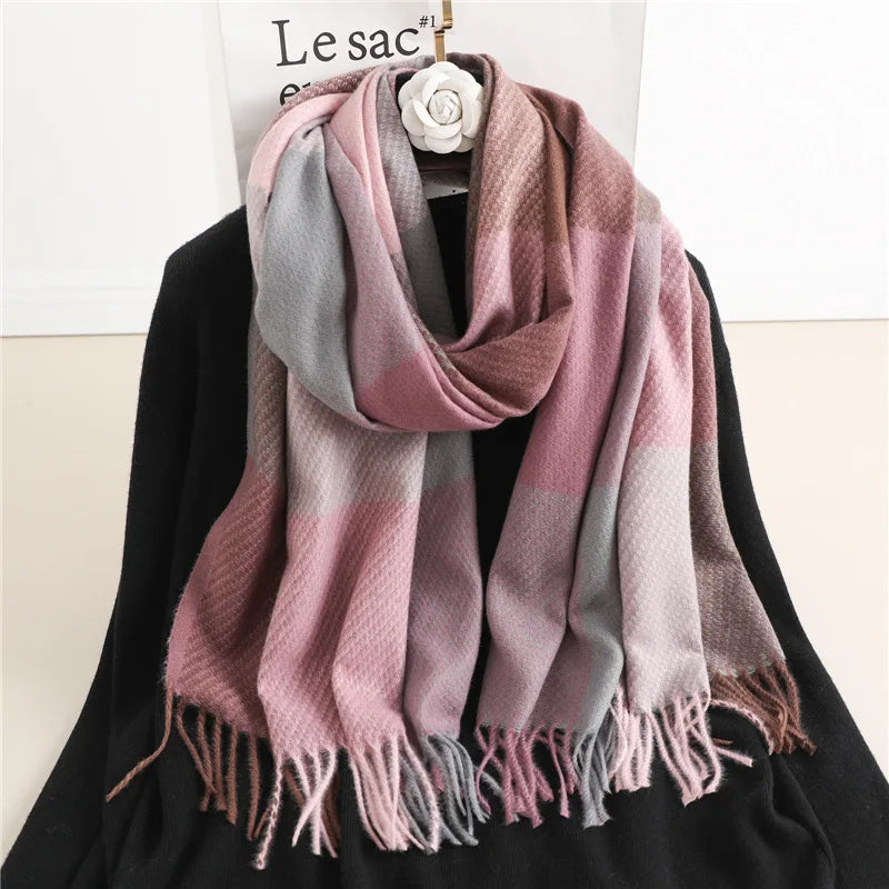 Pink and grey checked winter scarf displayed on a hanger