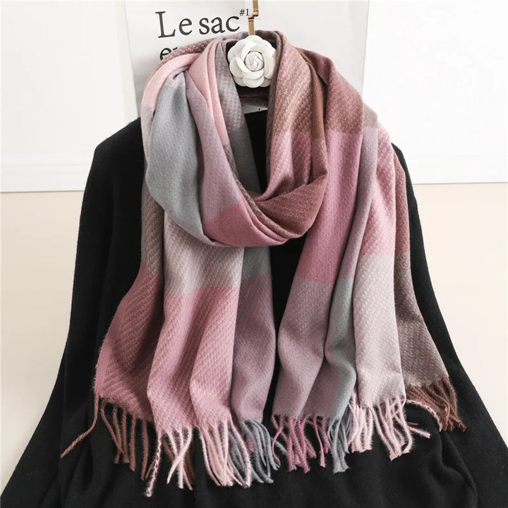 Pink and grey checked winter scarf displayed on a hanger