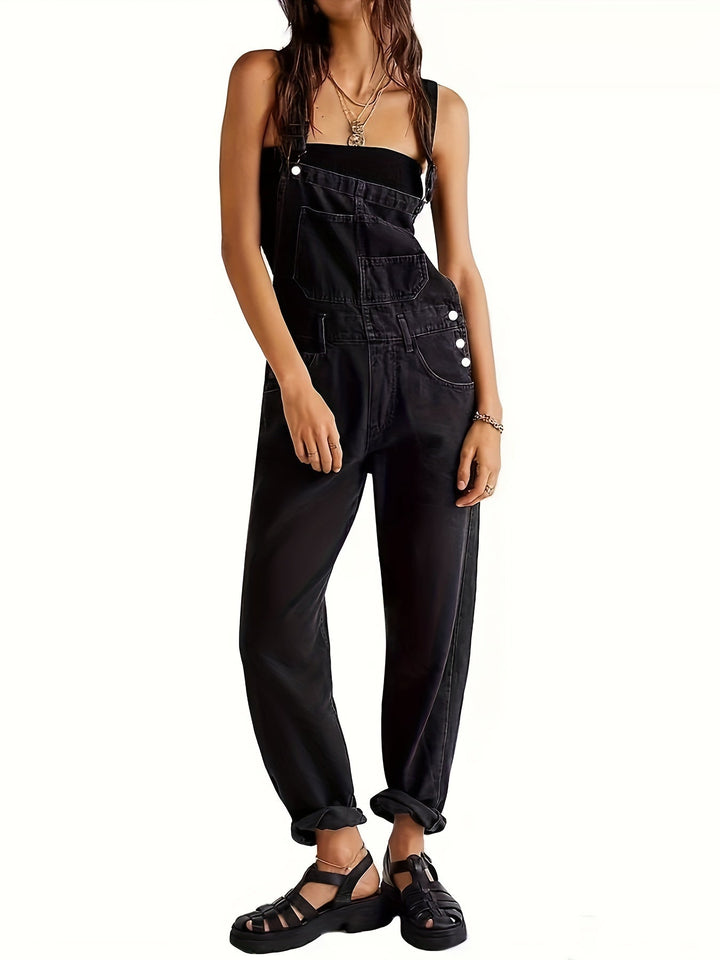 Detailed shot of a black denim jumpsuit paired with chunky sandals
