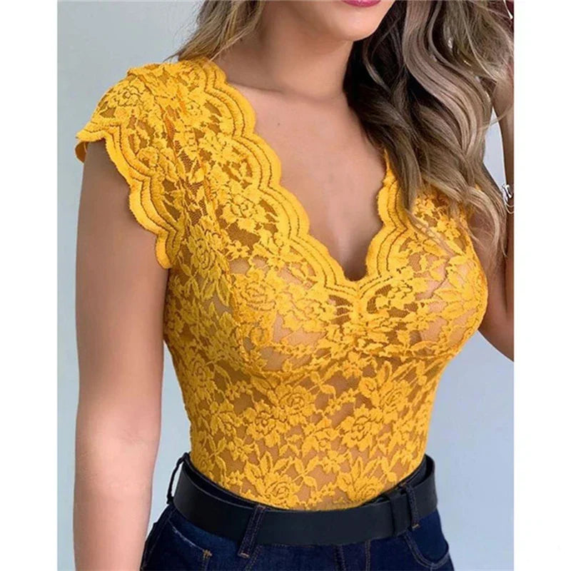Woman wearing a bright yellow floral lace summer top