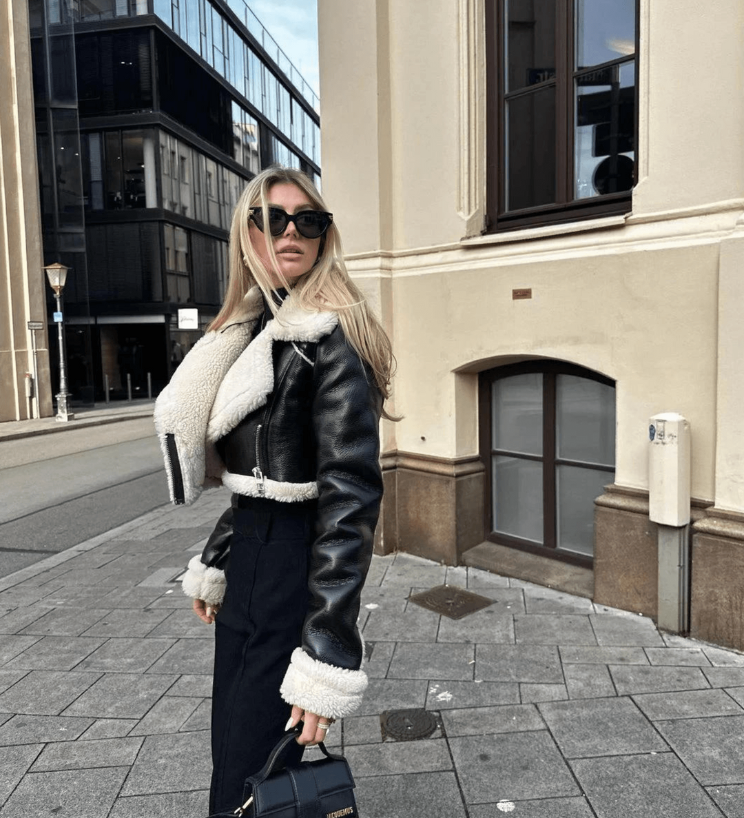 Side profile of a woman in a fashionable winter jacket on a city street