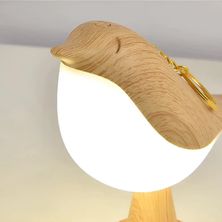 Close-up view of the beige LED bird lamp showing its detailed avian head design