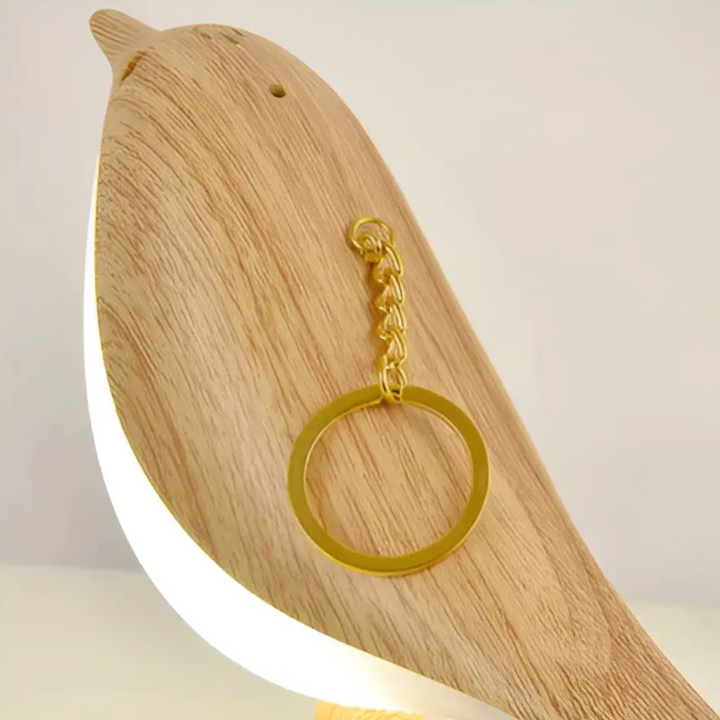 Modern touch-controlled bird desk light glowing softly on a wooden table