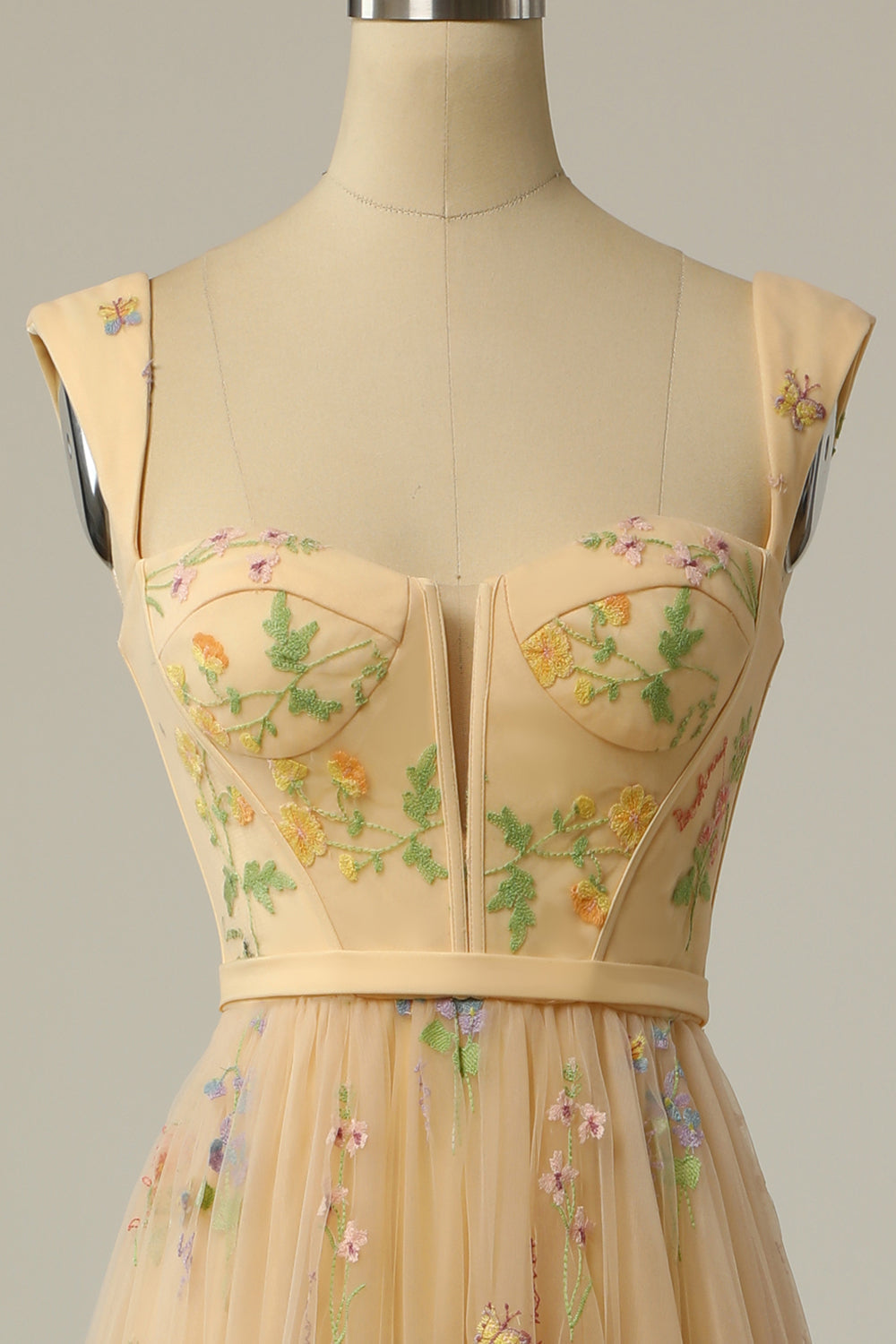 Detailed shot of the embroidered hemline on the party dress
