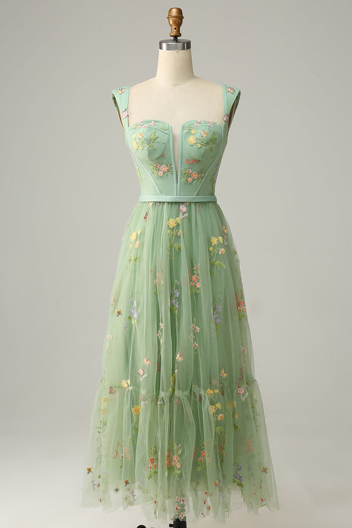 Front view of green embroidered a-line ball gown on mannequin