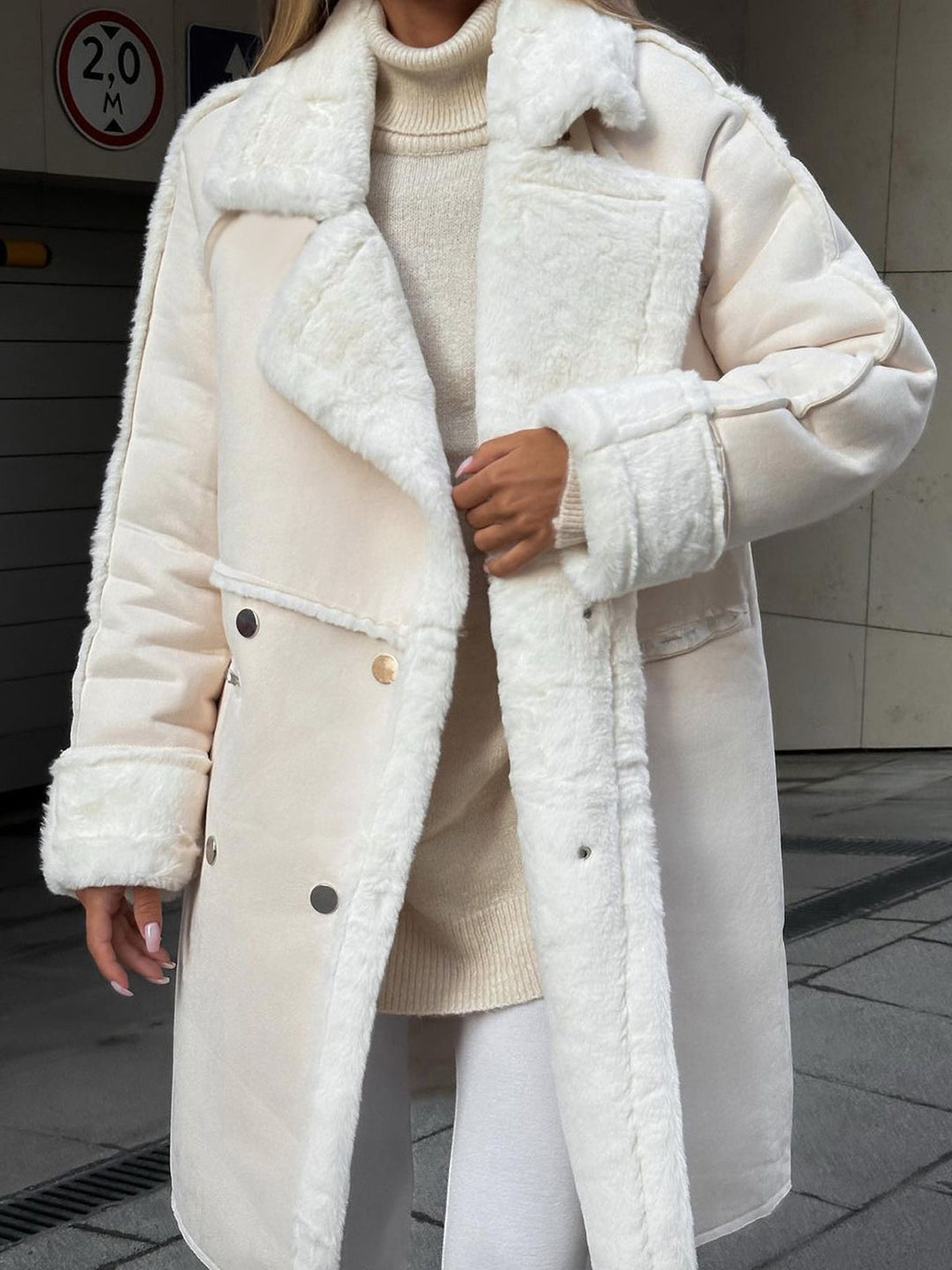 Close up view of the beige long fleece winter coat lapel and buttons