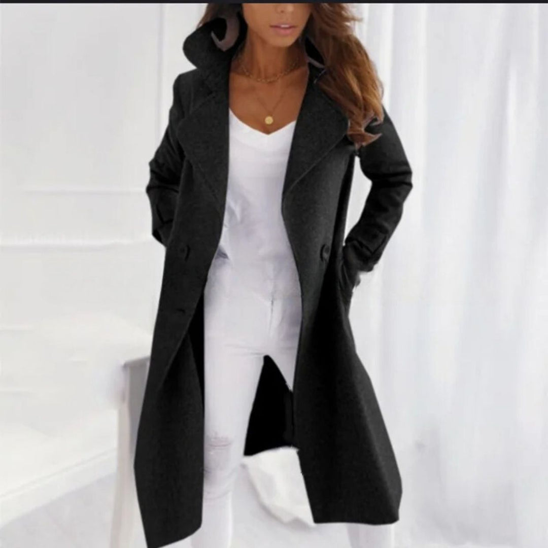 Woman wearing a black long coat with turned-down collar
