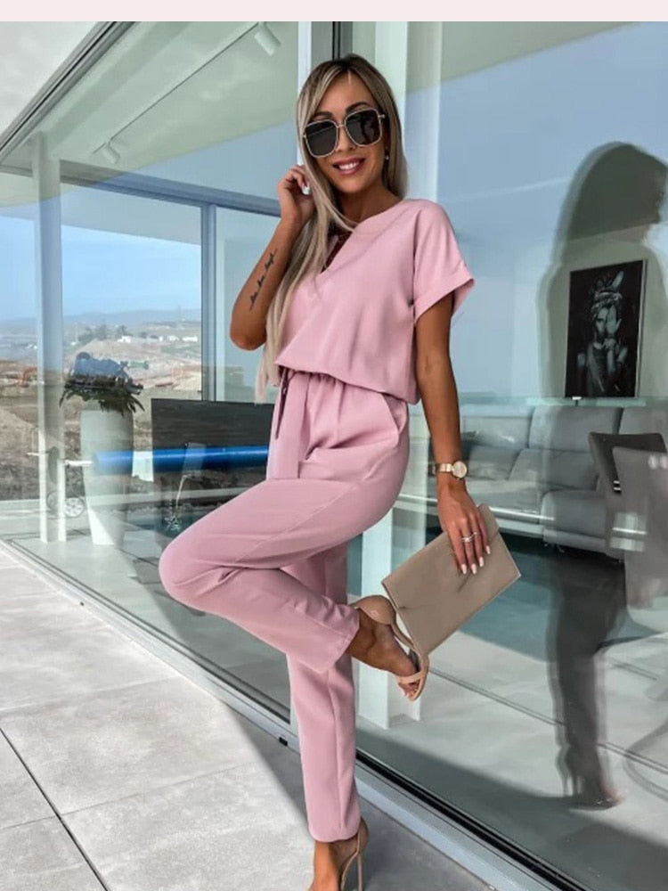 Elegant black one-piece jumpsuit with V-neckline and matching belt, evening wear