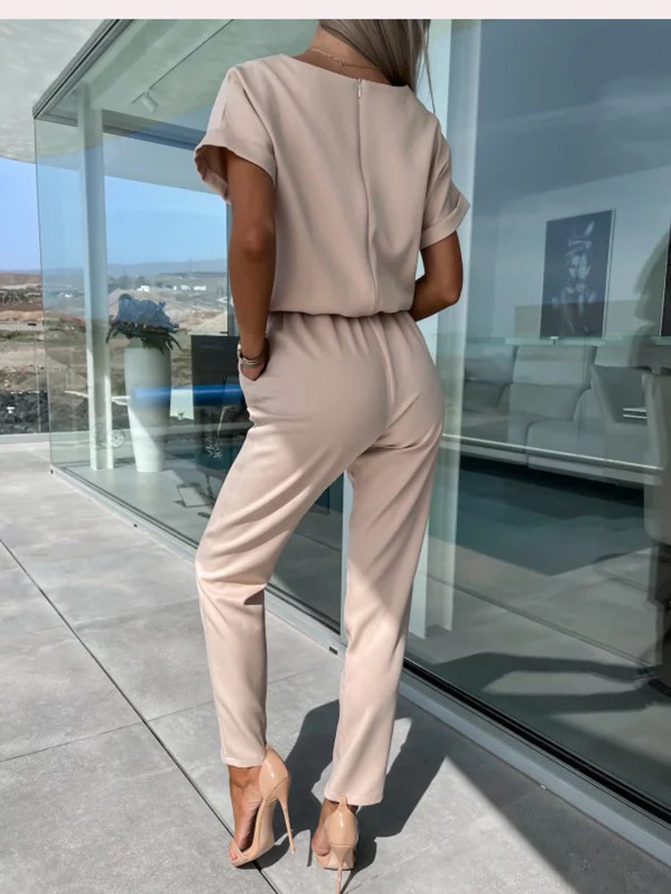 Full-length view of the black evening jumpsuit styled with heels and accessories