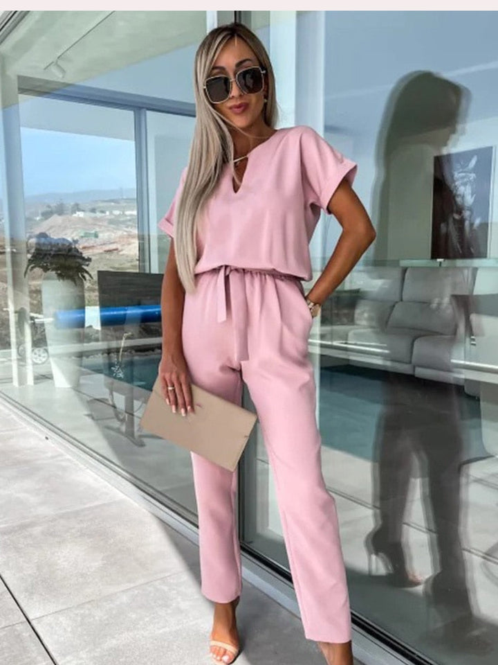 Pink women's V-neck jumpsuit featuring a stylish waist belt for casual wear