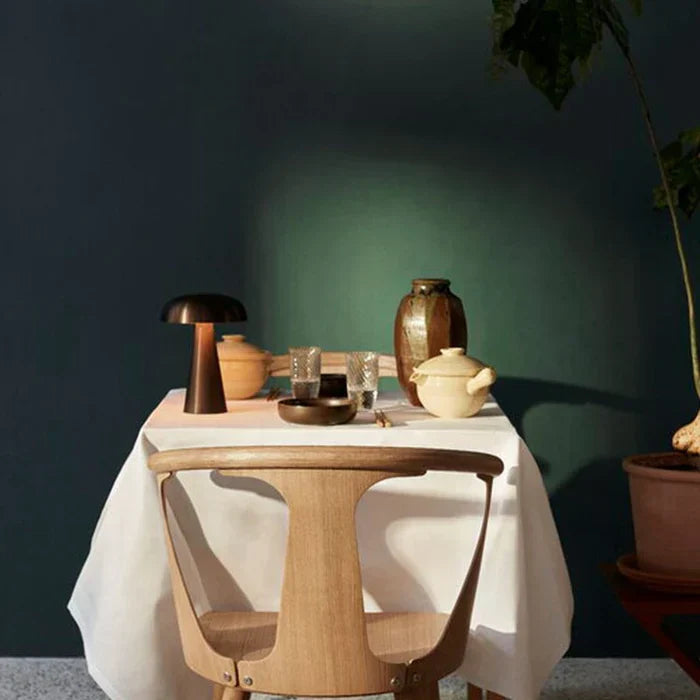 Cordless mushroom table lamp illuminating a cozy living room side table