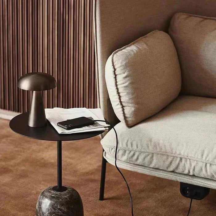 Portable table lamp glowing softly in a contemporary living space