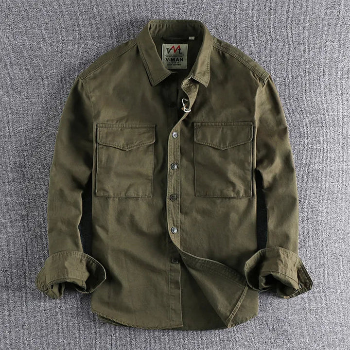 Military green men's utility shirt with dual chest pockets laid flat