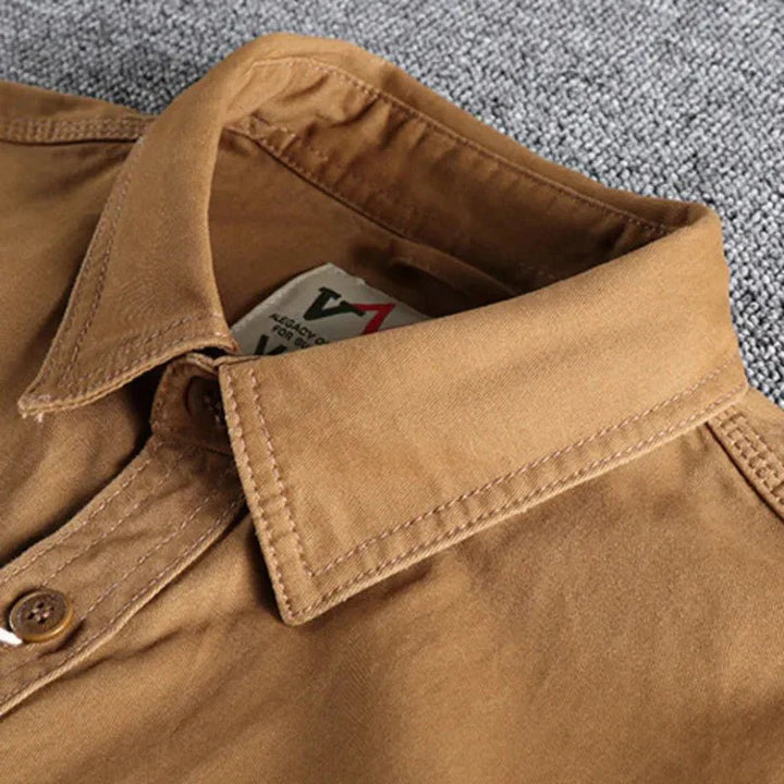 Military green men's utility shirt with button-down design and long sleeves