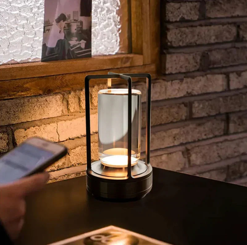 SolisAura wireless black lantern glowing warmly on a table