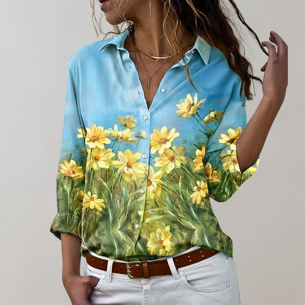 Woman wearing blue blouse with yellow floral meadow print
