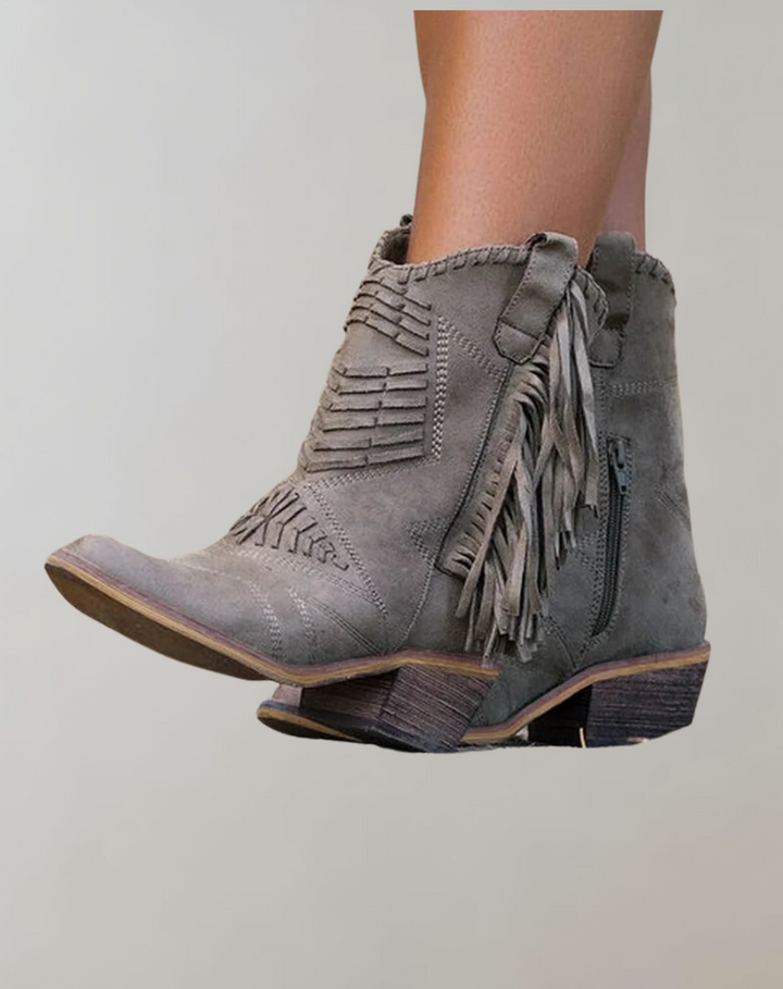 Grey women's ankle boot with side tassels and intricate stitching